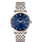 Watch with blue dial and two-tone rose gold and silver bracelet on white background